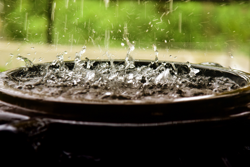 A photo of rain pouring into a pot for the Grade 4 Social Sciences Water in South Africa topic.